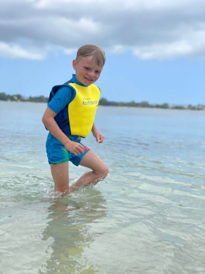 The five-year-old, who has autism, playing in the sea while on holiday in Jamaica