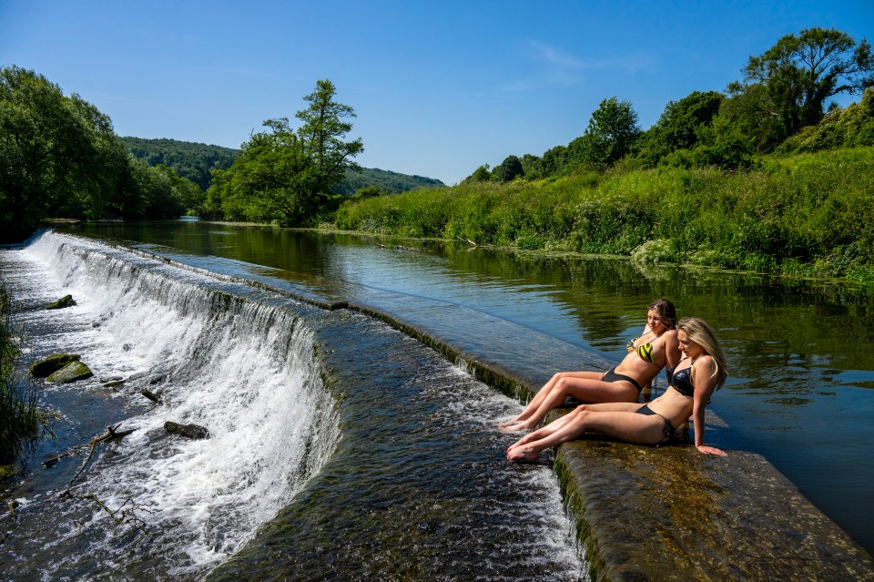 Two girls soaked up some rays at Warleigh Weir on the river Avon in Somerset