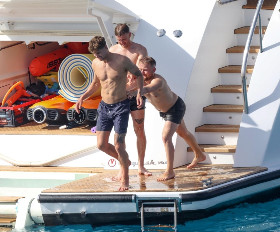 Stones is pushed into the Formentera water by some pals