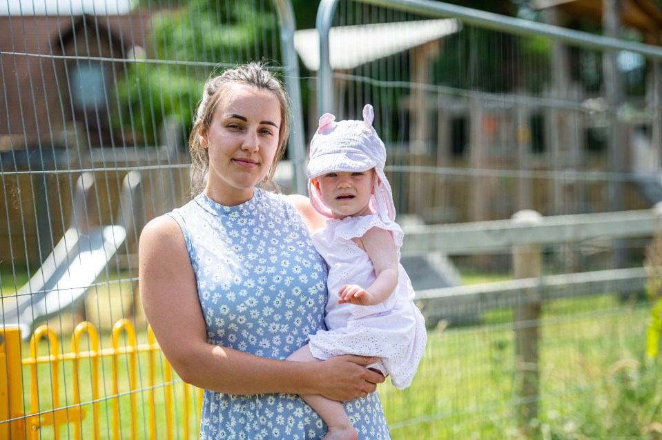 Georgia Darnier pictured with her 18-month-old daughter Ida beside the closed playground