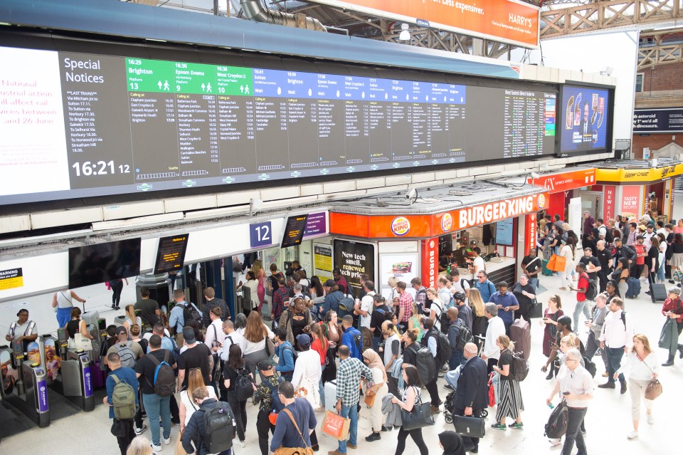 Fed-up passengers in London’s Victoria station check departures board