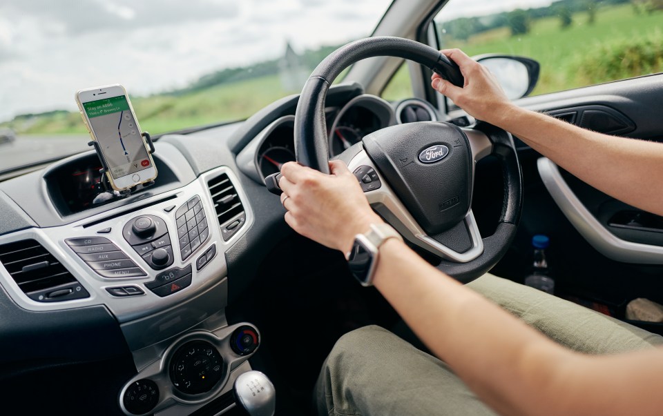 Motorist using their iPhone as a sat-nav