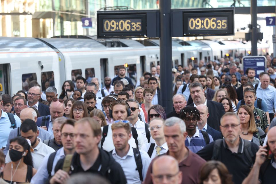 Passengers arrive at King's Cross Station this morning as train services continued to be disrupted