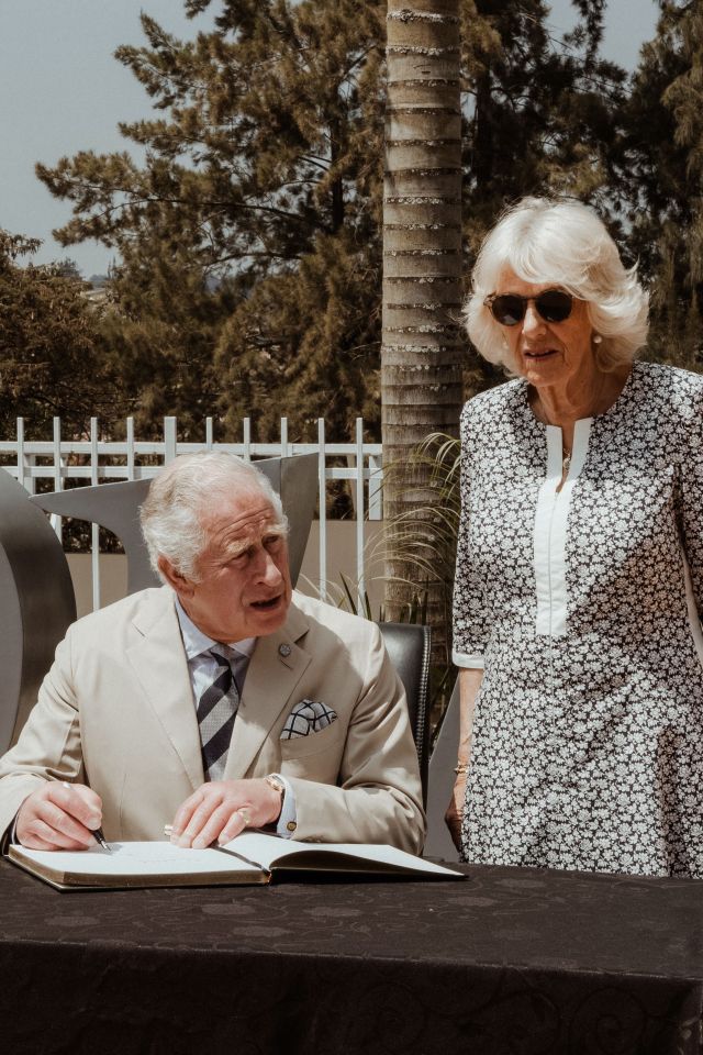 Charles writes a note on the guest book at the memorial