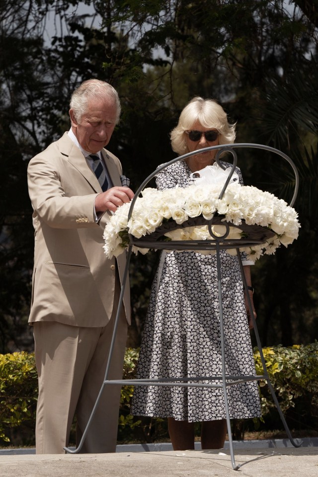 Charles and Camilla pause in front of a wreath at the Kigali Genocide Memorial