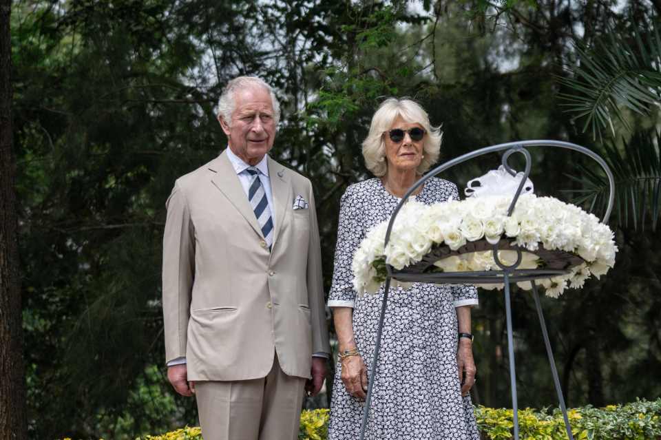 Boris and Camilla pause in front of a flower wreath at the Kigali Genocide Memorial, Kigali