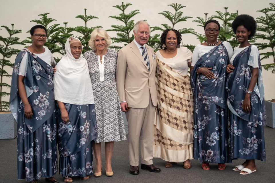 Charles and Camilla pose for a photo with a group of genocide survivors