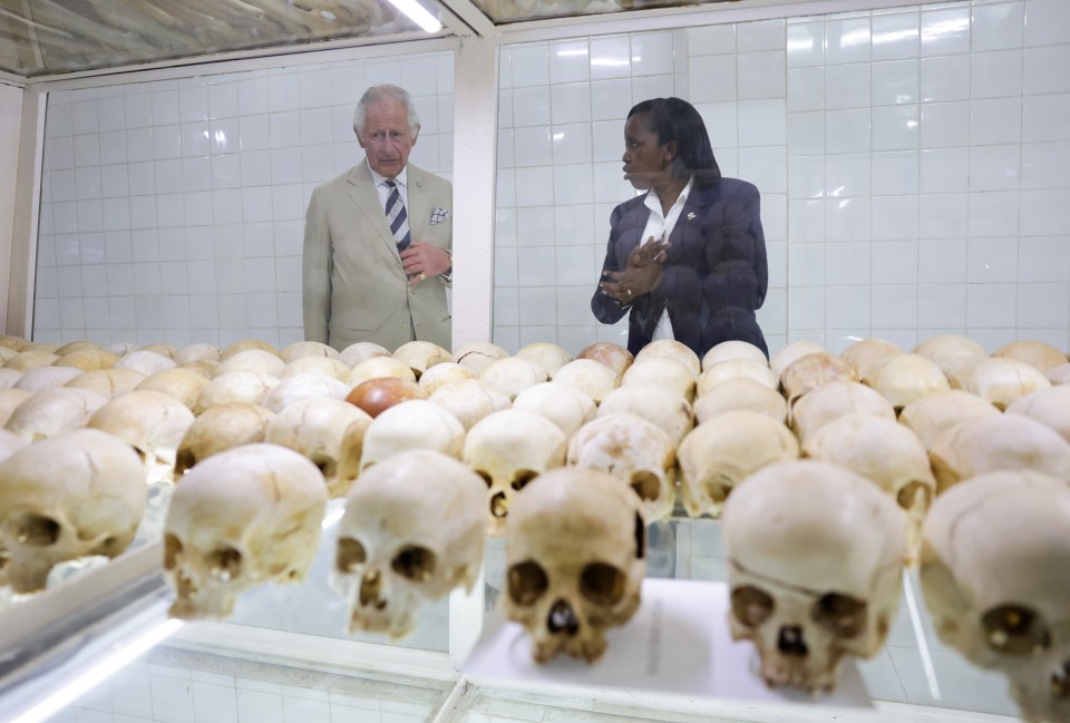 Prince Charles looks mournful as he is shown skulls of victims during a visit to the Nyamata Church Genocide Memorial