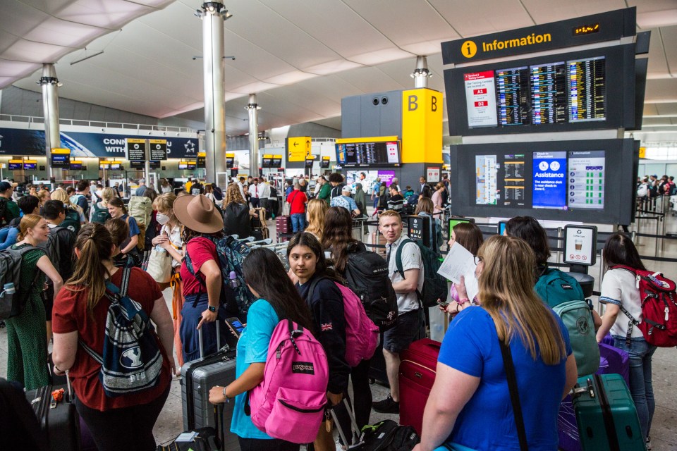 Crowds of travellers at Heathrow Airport in west London