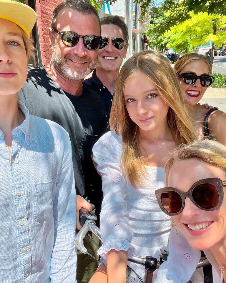 Kai, centre right, marking the end of her time at middle school with her older sister, mum, dad and . . . their new partners