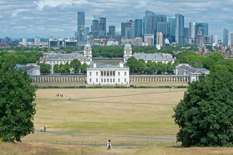 Dry brown grass in the park. People out and about in Greenwich Park