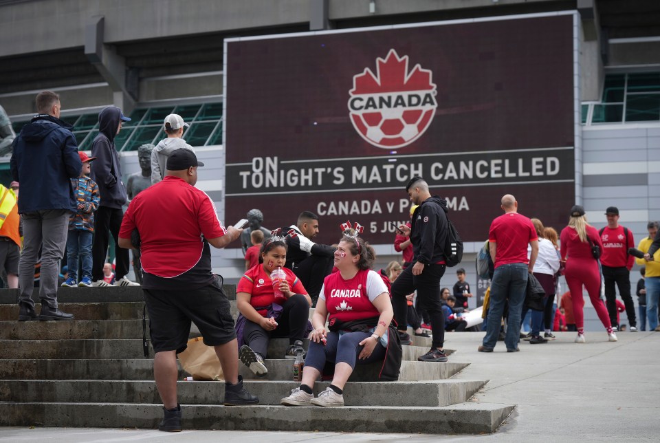 Fans sat outside the B.C Place stadium after the game was cancelled