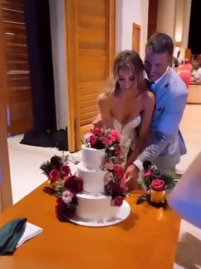 Jena Sims and Brooks Kopeka cut their wedding cake