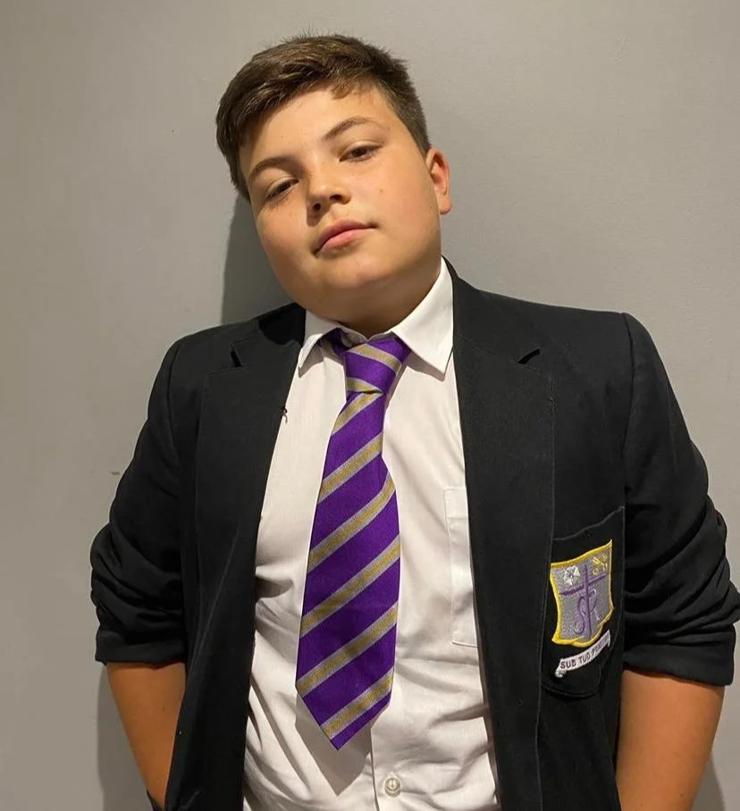 Year seven student Dex was forced to wear a shirt, tie, blazer and trousers in 32C heat