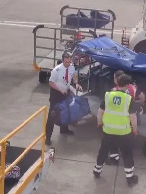 A pilot helped load luggage onto a badly-delayed plane at Edinburgh amid chaotic scenes at airports across the UK