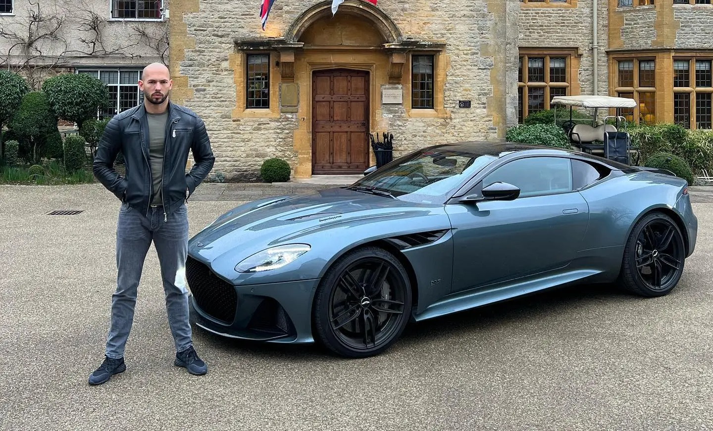 Tate pictured with a luxury Aston Martin super-car