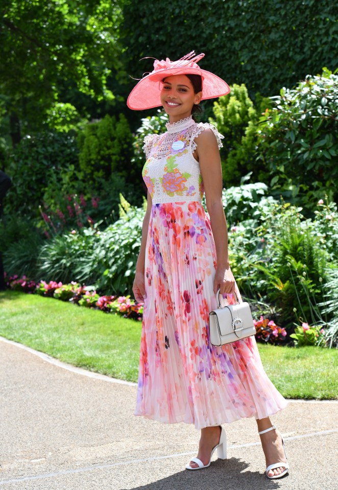 This Ascot racegoer looks pretty in pink wearing a pleated midi dress with lace detailing