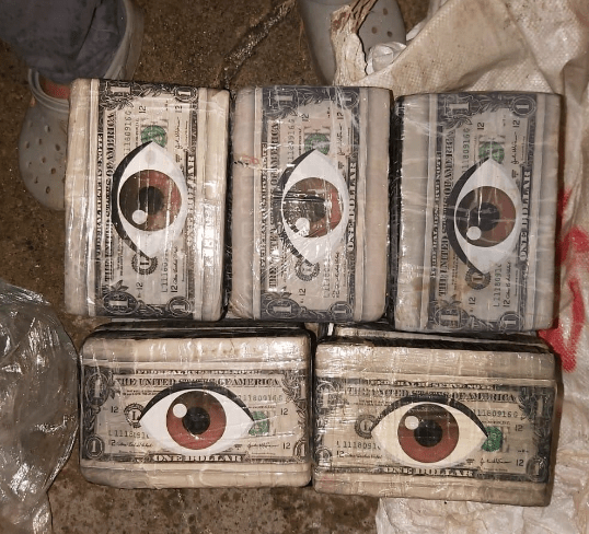 Blocks of cocaine wrapped with mocked up cash and strange eye symbols seized from Clan del Golfo