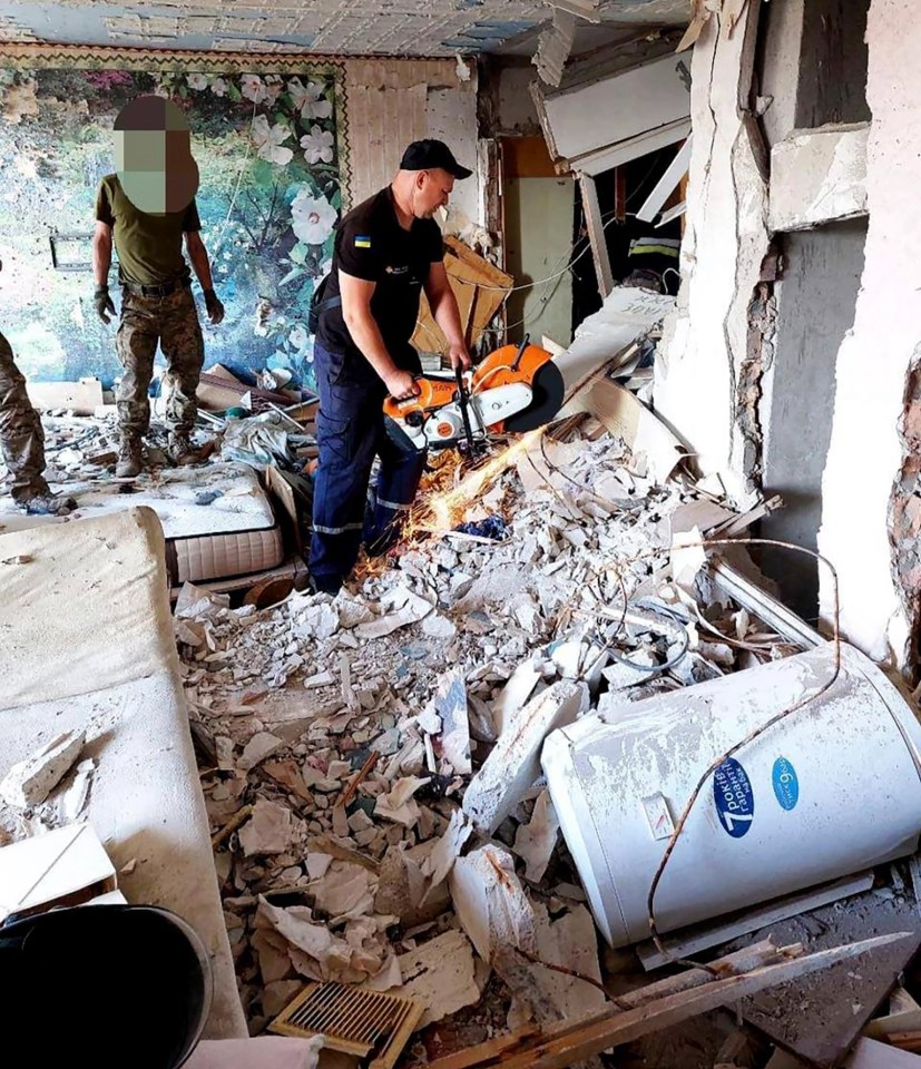 First responders work on a damaged residential building in Odesa