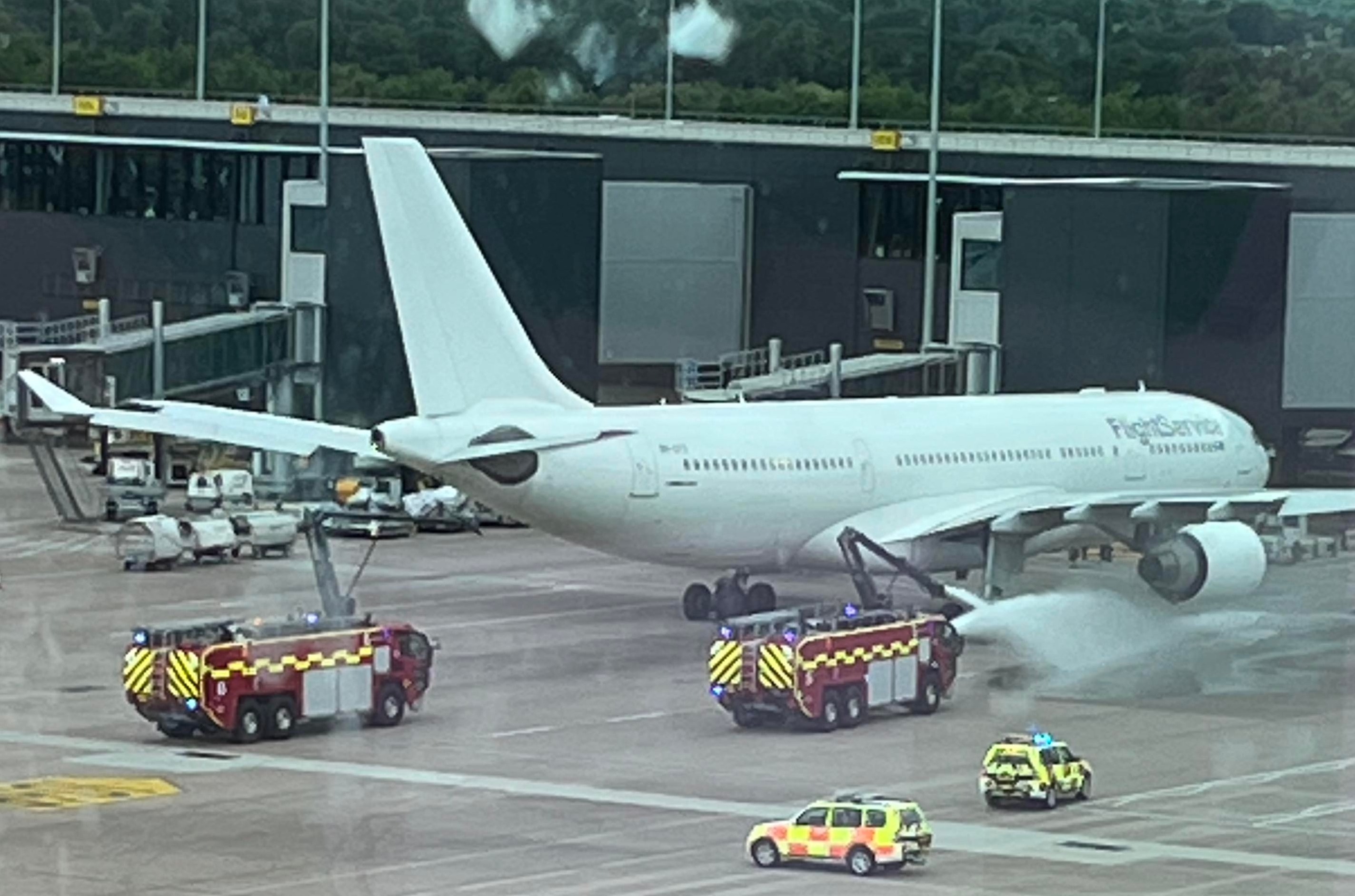 Eye witnesses said fire engines then began spraying down the right engine of the aircraft after it reportedly overheated.