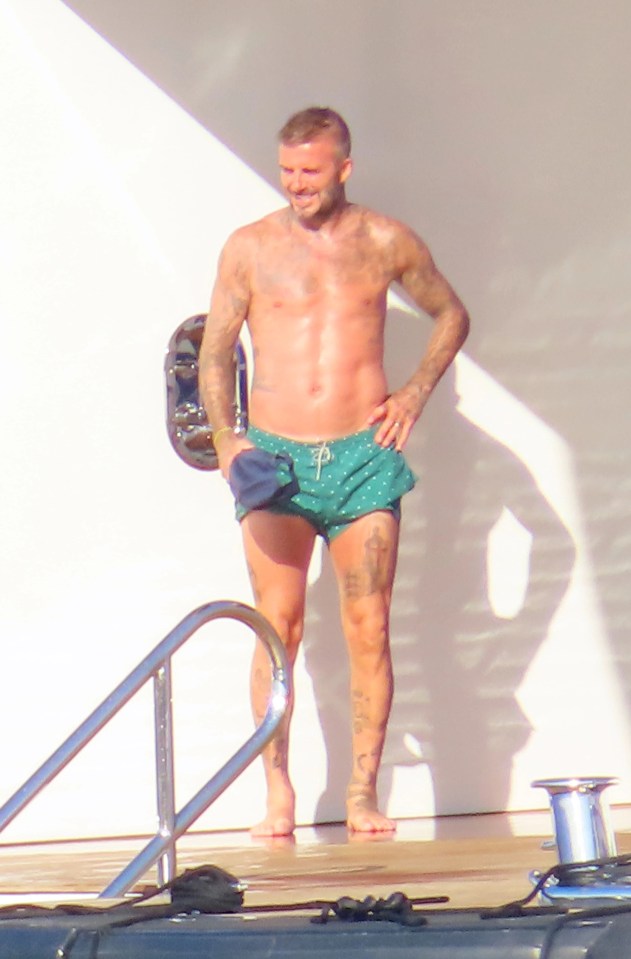 Becks showed off his incredible abs in green swim shorts