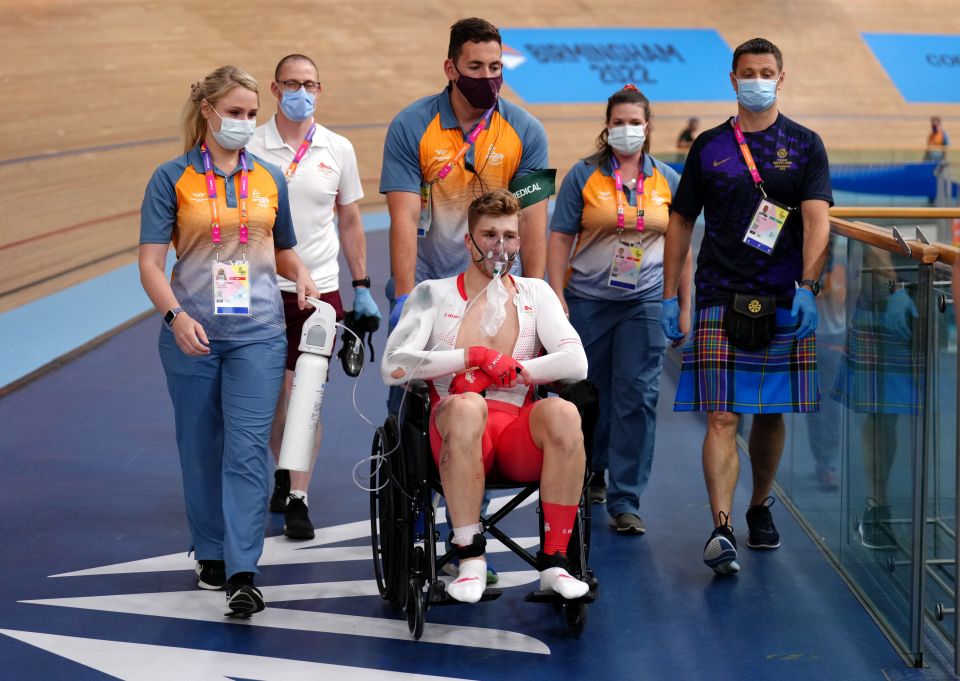 Joe Truman exited the velodrome in a wheelchair with an oxygen mask on