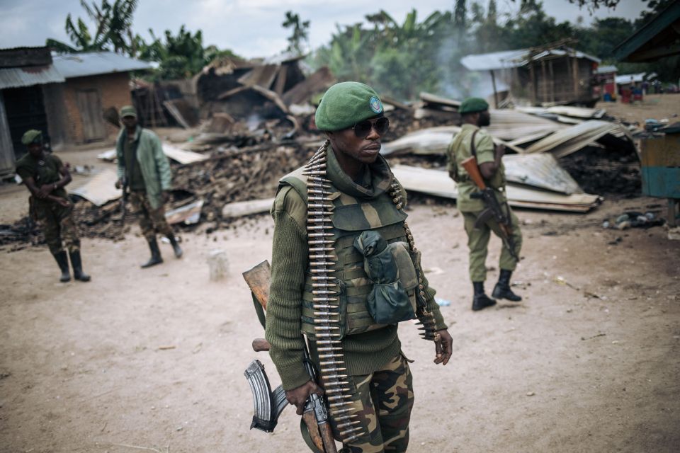 Armed Forces of the Congo soldiers takes part in a foot patrol in the village of Manzalaho near Beni