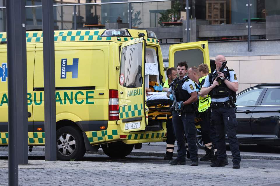 An ambulance and armed police are seen during the evacuation of people in Copenhagen, Denmark