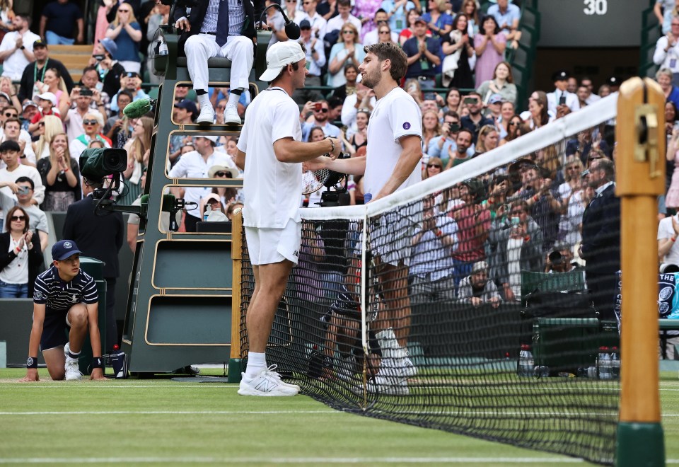 Norrie is congratulated by Tommy Paul at the net