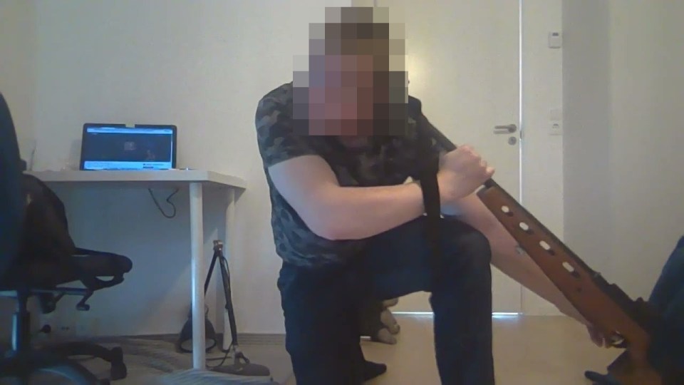 Twisted videos online appear to show the alleged gunman posing with weapons pointed at his head