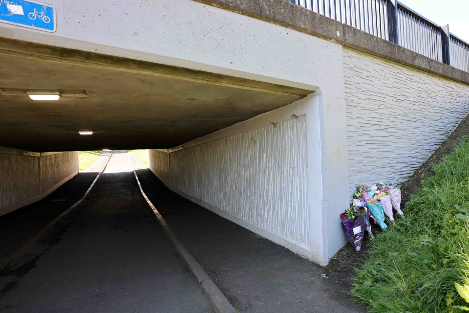 Flowers have been left next to an underpass near Romsey Close in Cramlington, the scene of the attack