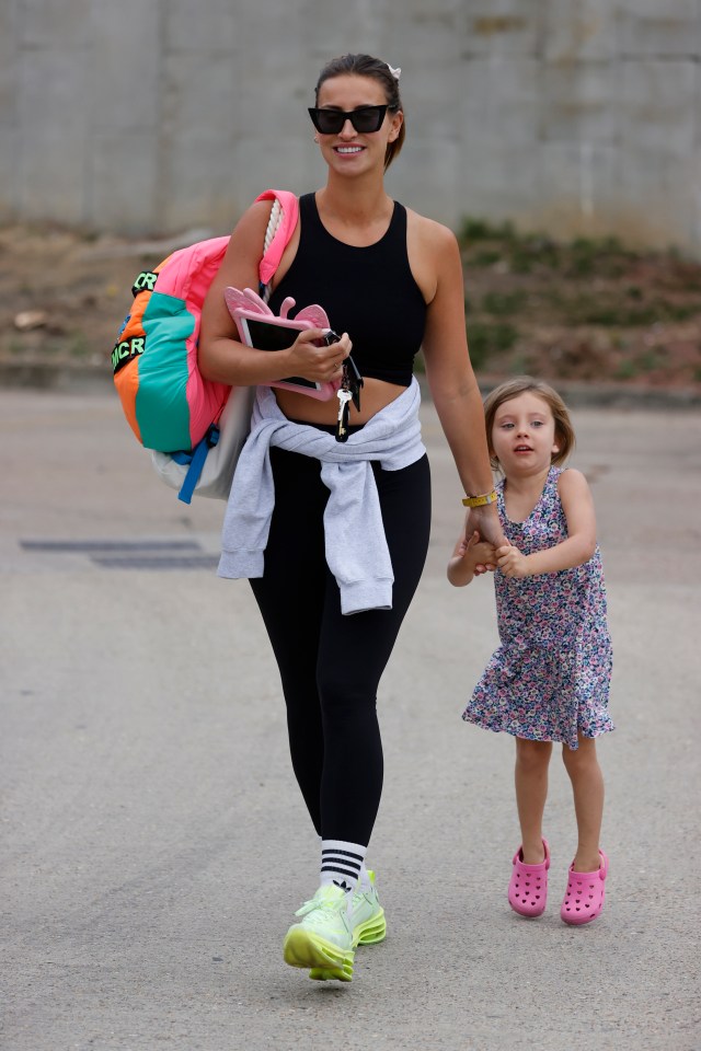 She was firmly in mum mode carrying daughter Sunday's iPad and bag