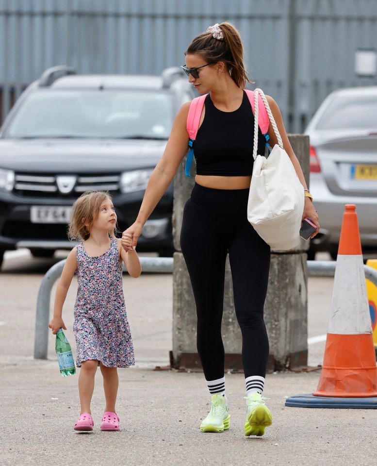 The stylish mum showed off her toned figure in a black gym co-ord