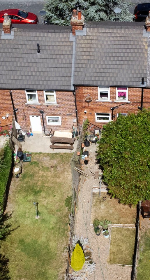 The neighbours' homes sit side by side and are separated by the wooden fence