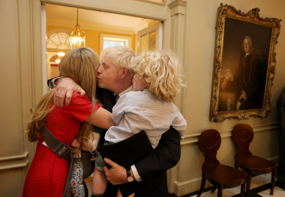 Boris Johnson was comforted by his wife Carrie and their children after delivering his statement in Downing Street