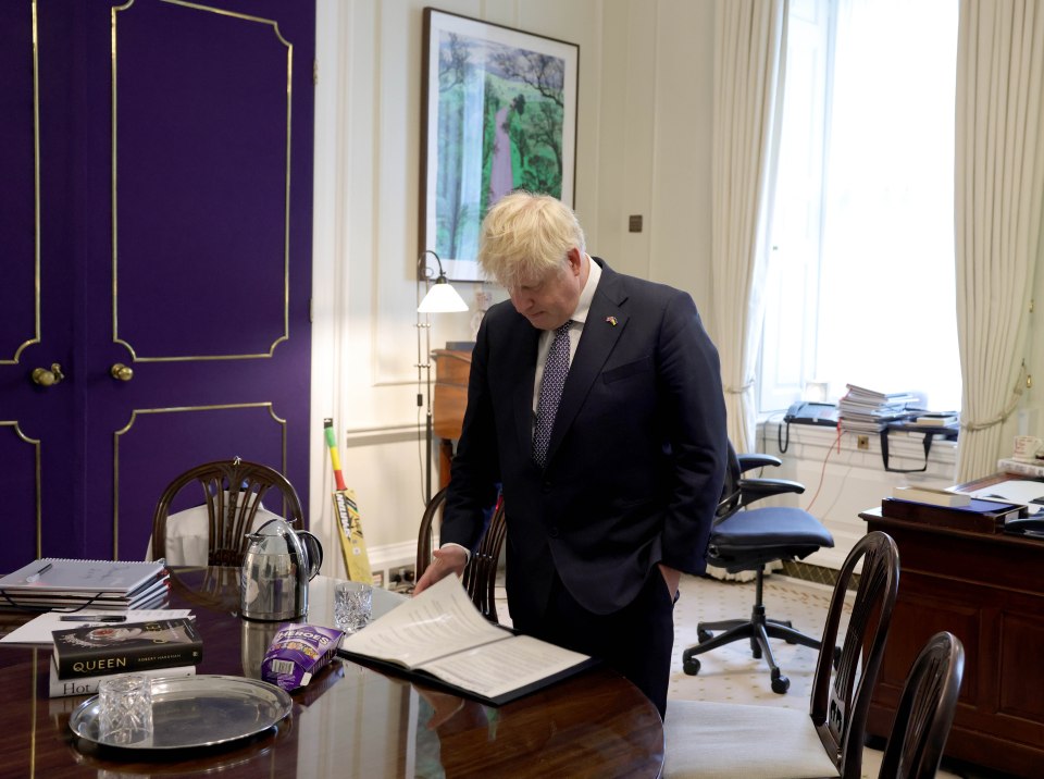 Boris Johnson reads his resignation speech, with chocolates bought by loyal supporters still on his No10 desk