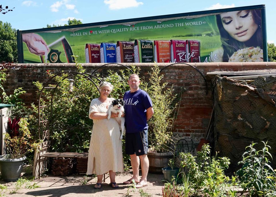 Claire and Mike O'Brien say their garden has been spoiled for them after a neighbour dumped two 15ft trailers behind their fence