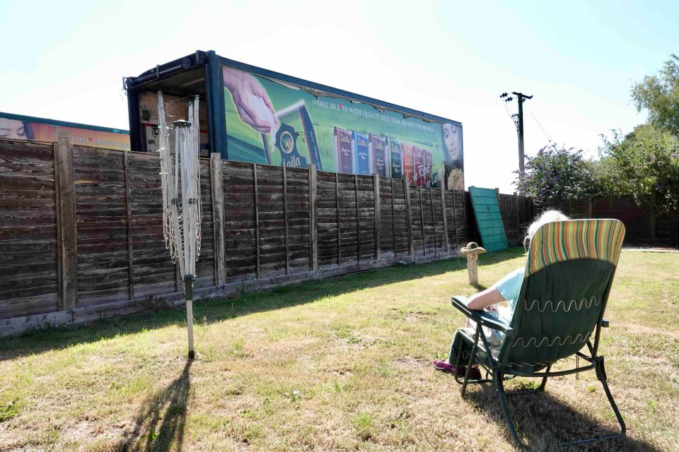 Mr Lake has told neighbours he plans to stick a roof between the vehicles for a 'hobby workshop'