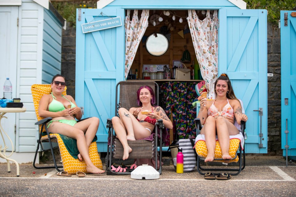 Friends Jessie, Scarlett and Holly enjoy an ice cream at their beach hut