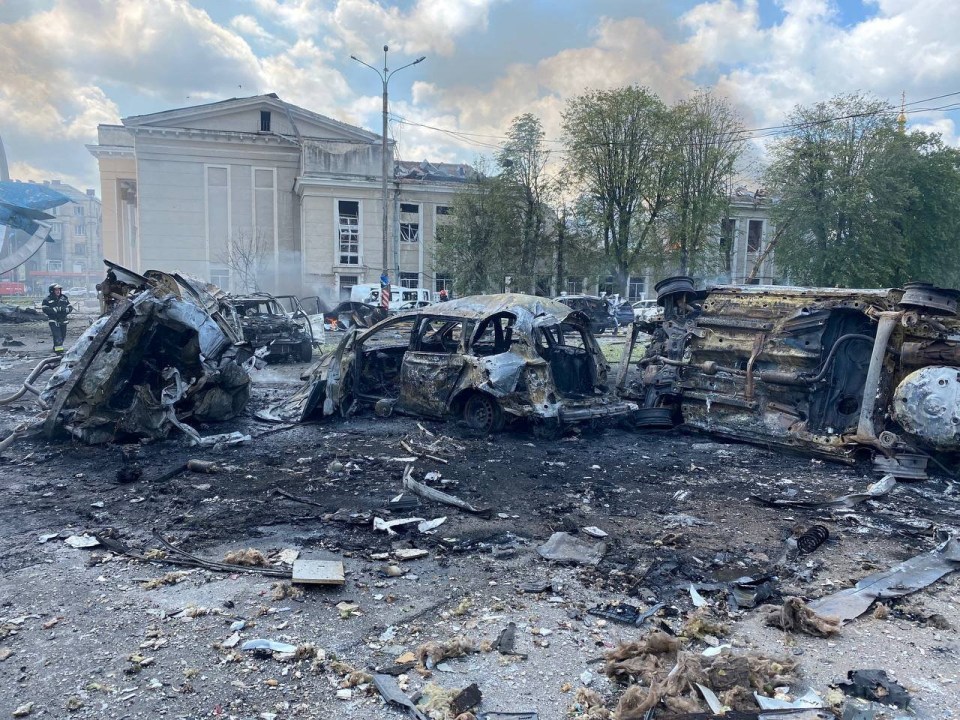 Destroyed vehicles are seen at the site of the Russian military strike