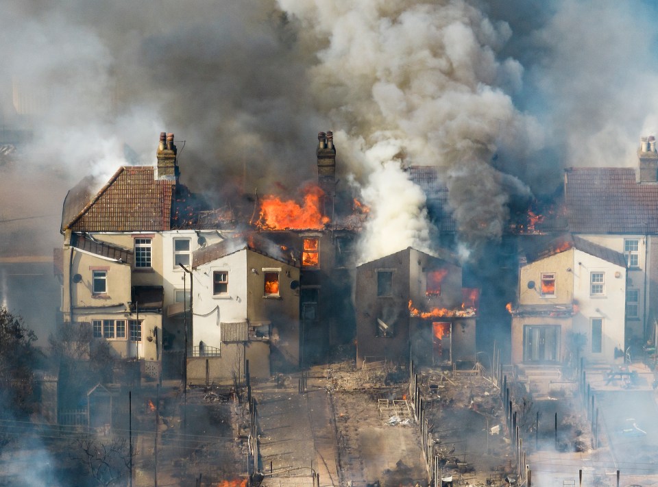 A row of houses on fire in the village of Wellington, East London