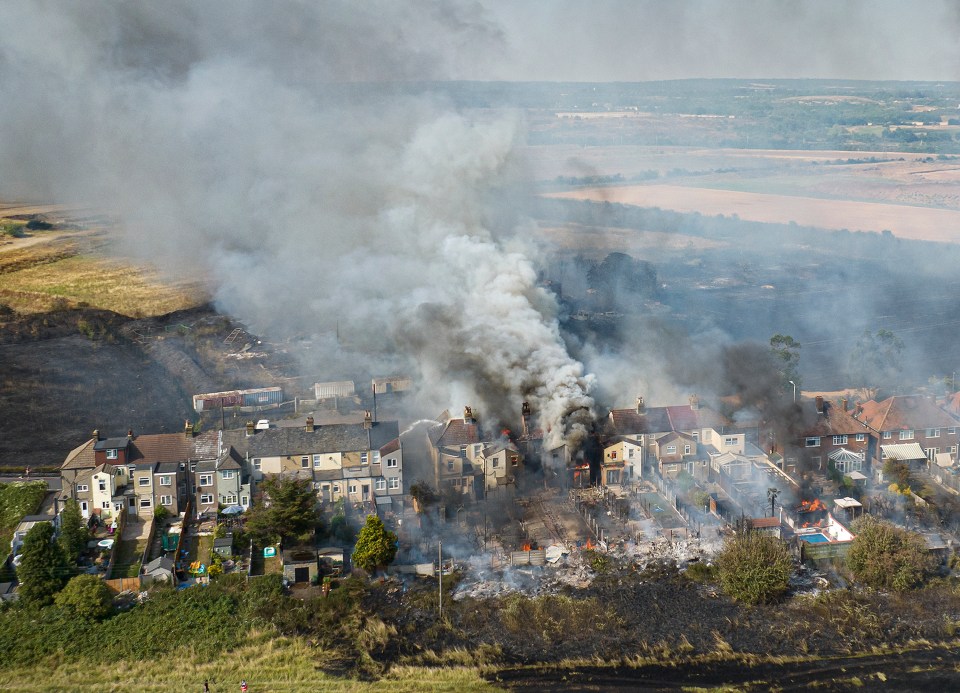 Aerial images showed fires ripping through properties at the tiny village of Wennington, East London