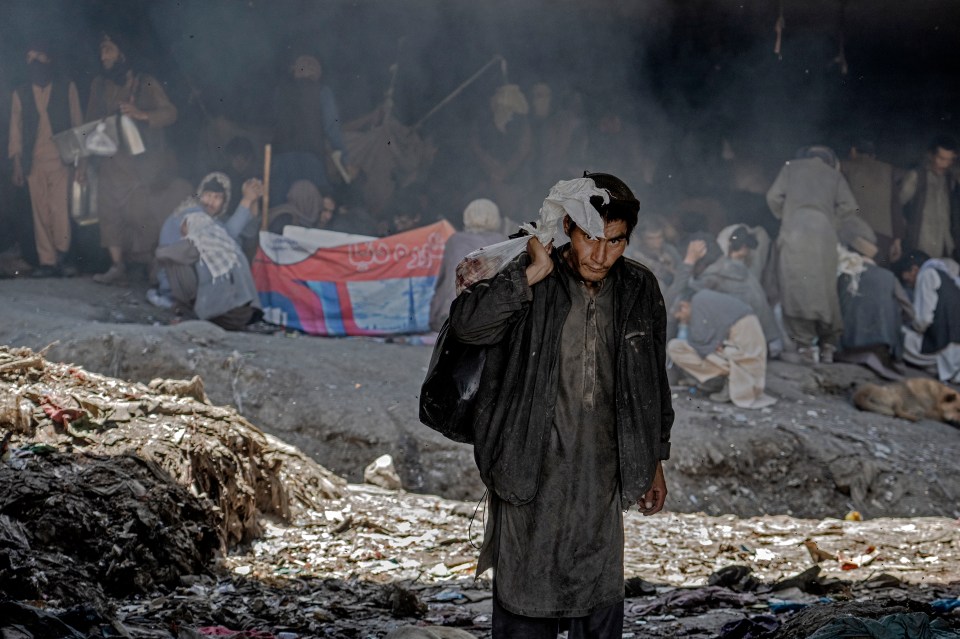 Hundreds of Afghans addicts gather under a bridge to consume drugs