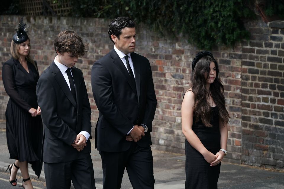 Husband Sebastien Bowen walked with his children on the procession