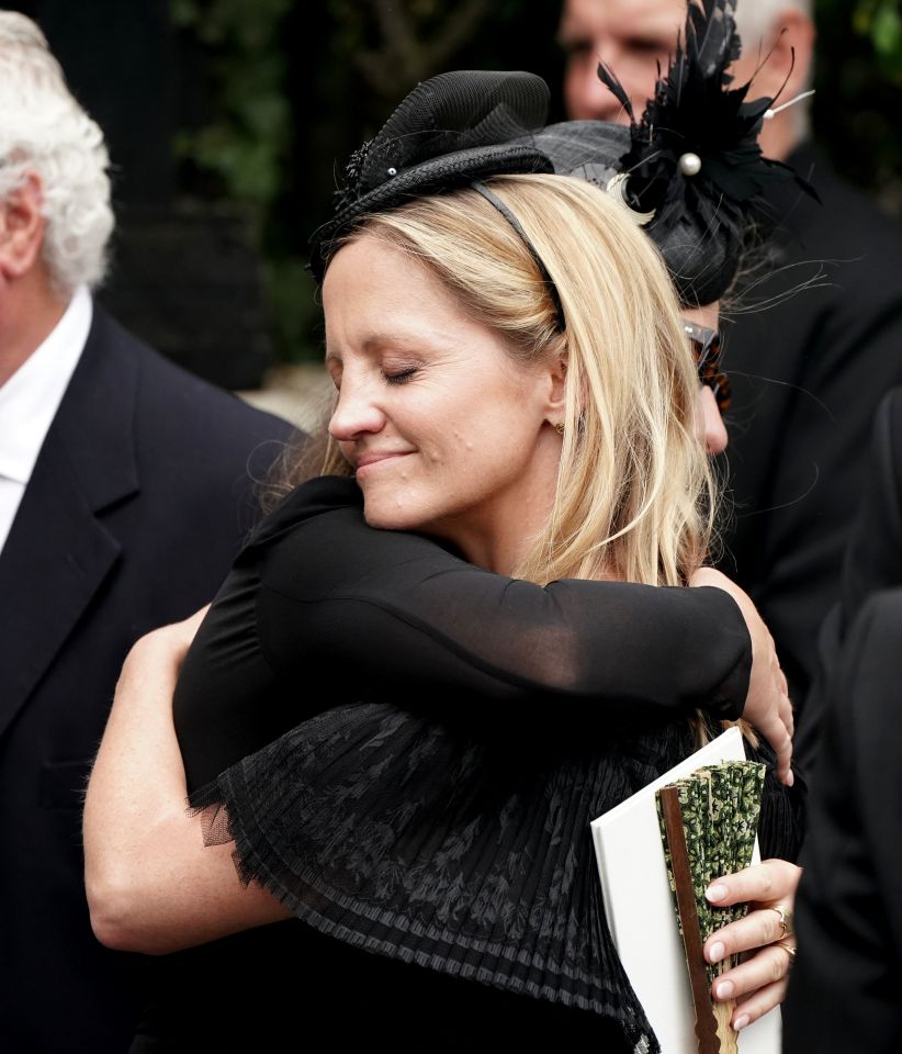 Deborah's sister Sarah James embraces a mourner as she leaves the funeral