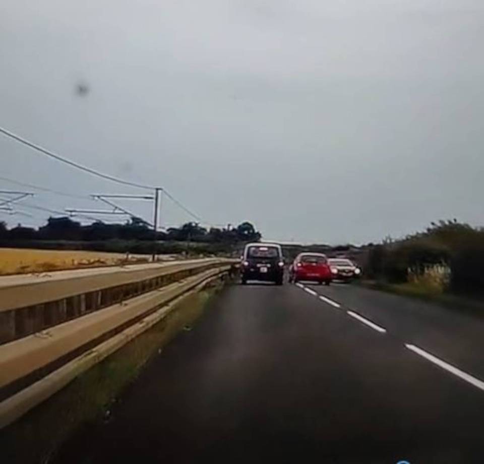 Oncoming traffic is forced to swerve off the road to avoid the overtaker