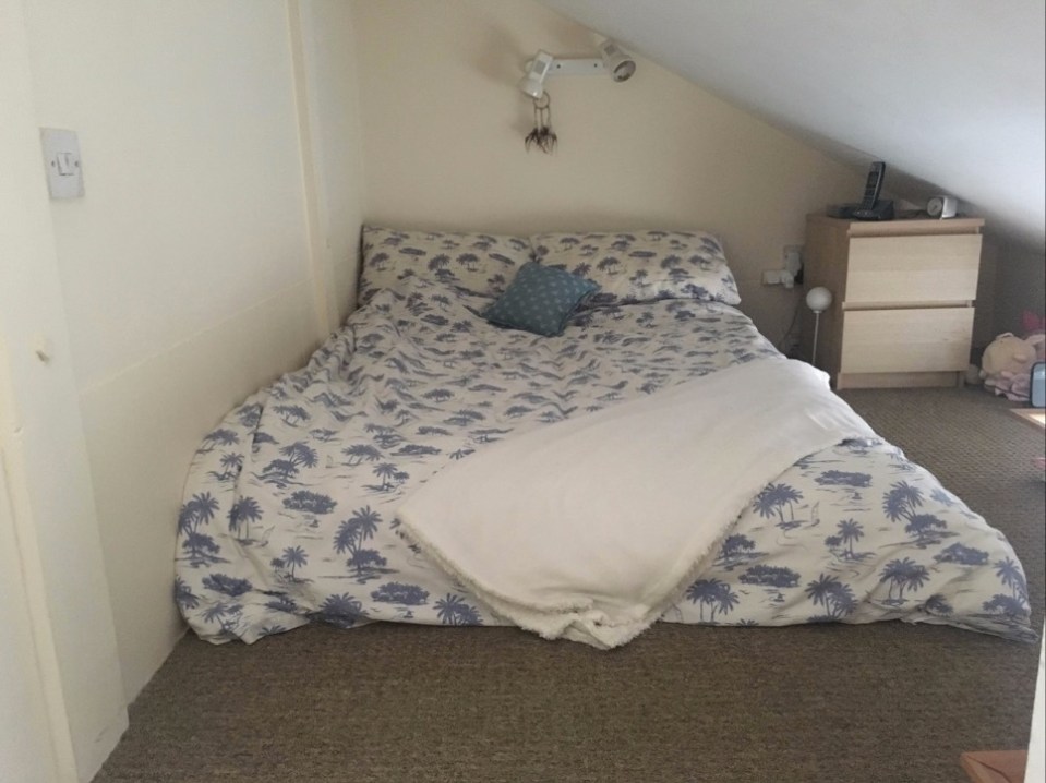 The tiny bedroom is squeezed into a crawl space above the ceiling