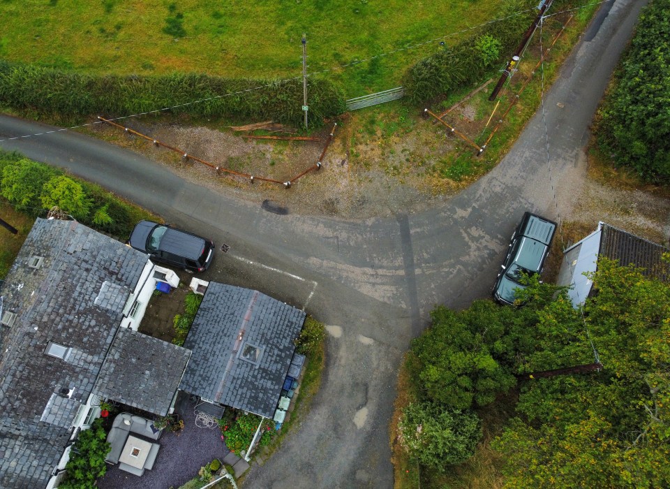 The couple say the 130ft-long barrier 'makes no sense'