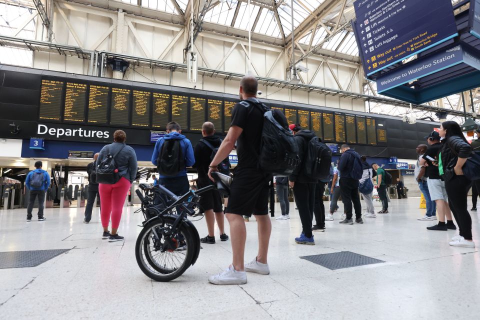 Passengers assess the situation at Waterloo Station in London