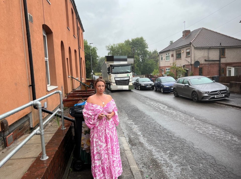 Resident Emma Martin outside her rat and fly-infested home in Salford